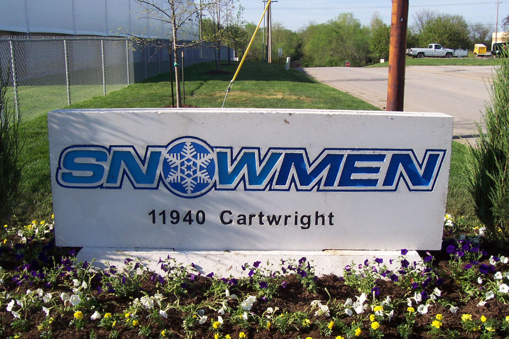 The logo of Snowman with a snowflake in it outside of a building